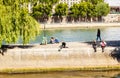 Island of the City. People sit on Quai des Orfevres. Paris Royalty Free Stock Photo