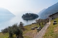 Island Comacina in the fog, surrounded by Lake Como, Italy Royalty Free Stock Photo