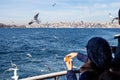 Island Ferry Ada Vapuru. Some of the ferry passengers feed seagulls. Passenger ferryboats from Istanbul sail regularly to the Pr