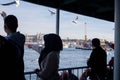 Island Ferry Ada Vapuru. Some of the ferry passengers feed seagulls. Passenger ferryboats from Istanbul sail regularly to the Pr