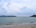 Island with Forest, Cloudy Sky, Calm Sea Waves at Sandy Beach - Landscape of Ross Island and Port Blair, Andaman Nicobar, India Royalty Free Stock Photo