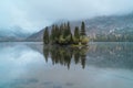 An island frosted with the first snow of the year on a cold lake Royalty Free Stock Photo