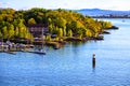 Island with harbor and sailboats, view from the water