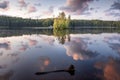 Island on the lake at sunset with reflection  summer evening Royalty Free Stock Photo