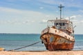 An old weathered and rusting ship/fishing boat anchored on the beach of the Island of Mozambique Ilha de Mocambique on a sunny