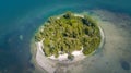 Island in ocean. Small green uninhabited beach or tiny desert island. Blue-turquoise color Gulf of Mexico water. Beautiful wildlif