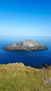 The Chick . The Island off Kelsey HeadKelsey Head is the site of an Iron Age Cliff Castle Royalty Free Stock Photo