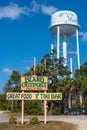 Island Outpost Grill and Bar sign and Ozello water tower, vertical shot - Crystal River, Florida, USA Royalty Free Stock Photo