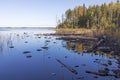 island overgrown with trees on Lake Onega in Karelia in autumn. Reflections in water Royalty Free Stock Photo