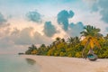 Tropical sunset beach and sky background as exotic summer landscape with beach swing or hammock and white sand and calm sea beach Royalty Free Stock Photo