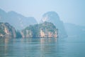 Island and rocks in thailand near the blue sea in fog Royalty Free Stock Photo