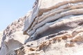 In the island of santorini the coast is composed of immense walls of hard sand drawn by the constant winds