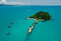 Island with touristic boats and blue ocean in Florianopolis, Brazil. Aerial view