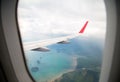 Island view through aircraft windows over the sea