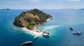 Island with white beach clear water and boats