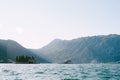 Islands of the Bay of Kotor against the backdrop of mountains in bright sunshine. Montenegro