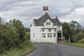 Strange ancient old house on the corner of a main road Royalty Free Stock Photo