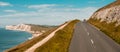 The Isle of WIght, UK. Road and white cliff of the Needles. Beautiful land view of white rocks and blue sea. Hills with Royalty Free Stock Photo