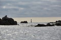 Isles of Scilly, United Kingdom - Bishop Rock Lighthouse in the distance between rocks in the foreground