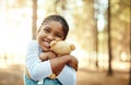 Isnt she just the cutest. Portrait of a little girl playing in the woods with her teddybear. Royalty Free Stock Photo