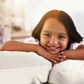 Isnt this just the cutest smile youve ever seen. Cropped portrait of a little girl lying on the sofa at home. Royalty Free Stock Photo