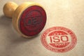 ISO 9001 certified concept. Rubber stamp with the text ISO 9001 on craft paper background. Quality control Royalty Free Stock Photo