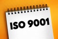 ISO 9001 - international standard that specifies requirements for a quality management system, text concept on notepad