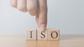 ISO word on wooden cube quality control concept ISO standard assurance in