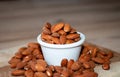 Almonds seed on in porcelain bolw on wooden table Royalty Free Stock Photo