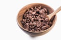 Isolate cocoa cereal on wooden bowl