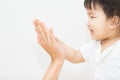 Isolate cute asian baby touch hand with mother Royalty Free Stock Photo