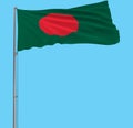 Isolate flag of Bangladesh on a flagpole fluttering in the wind on a blue background.