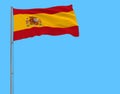 Isolate flag of Spain on a flagpole fluttering in the wind on a blue background, 3d rendering Royalty Free Stock Photo