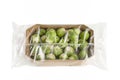 Isolate of fresh Brussels sprouts in paper wrapping and a transparent plastic bag. Brussels sprouts in transparent Royalty Free Stock Photo