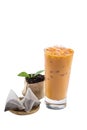 Isolate Iced Thai Tea glass cup with dried and fresh tea leaves. Royalty Free Stock Photo