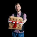 Isolate Man holding a box of Christmas gifts in his hands on sale. The father gives family gifts. Christmas sale, discounts Royalty Free Stock Photo
