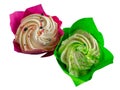 Isolate of two cupcakes in green and red packaging