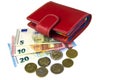Isolate on white. EU cash. Banknotes of 5, 10, 20 euros. Some coins. Woman`s red wallet Royalty Free Stock Photo