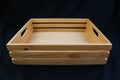 Isolate wooden box with grip handle on black background.