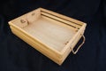 Isolate wooden box with rope grip handle on black background.
