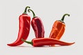 Isolated against a white background, three fiery red chili peppers Royalty Free Stock Photo
