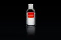 Isolated alcogel hand disinfectant in a small plastic bottle with red label.