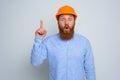 Isolated amazed architect with beard and orange helmet