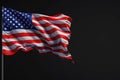 Isolated American flag with stars and stripes waving in wind on pole against black background. AI Generated Royalty Free Stock Photo