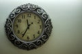 Isolated Ancient Designer Wall Clock With Light Yellow Back Ground showing time 11:35 o`clock and free spac on right side