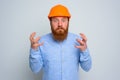 Isolated anger architect with beard and orange helmet