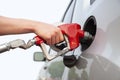 arm and hand of a young man pumping gas into a car Royalty Free Stock Photo