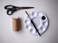 Craft Supplies - Toilet Paper Roll, Paint and Paintbrush and Scissors Isolated on Dark Grey Background