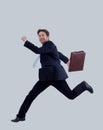 Isolated attractive business man running away from someone. Royalty Free Stock Photo