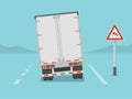 Isolated back view of a truck on windy road. Crosswinds ahead sign area. Royalty Free Stock Photo